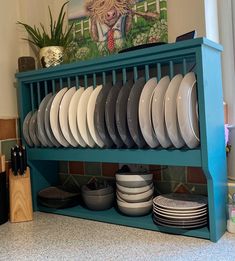 a blue shelf filled with plates and bowls