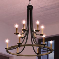 A beautiful UEX2381 Lux Industrial Chandelier hangs in a room. Foyer Chandelier Black, 2 Story Foyer Chandelier, Black And Brass Chandelier, Entry Lights, Layered Candles, Entryway Light Fixtures, Modern Farmhouse Chandelier, Entryway Chandelier, Entry Lighting