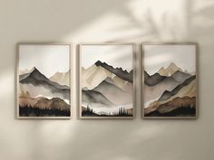 three paintings are hanging on the wall