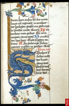 an old book with writing on it and a blue dragon in the middle, surrounded by flowers