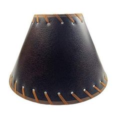 a black lamp shade with brown stitching on it