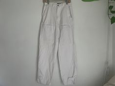 "Great white jeans from the 80s with adjustable back waist straps and suspender buttons  100% cotton  Labeled size 8 Measurements taken flat double when necessary  Waist 13\" adjustable straps in back can cinch tighter Hips 23\" Rise 11.5\" Inseam 31\" Ankle 8\"" White Utility Pants With Belt Loops, White High Waist Utility Cargo Pants, White Cotton Cargo Pants With Belt Loops, White Utility Jeans With Belt Loops, High Rise White Cargo Pants For Work, White Utility Jeans For Work, White High Rise Utility Jeans, White Utility Jeans, Summer White Cargo Pants With Belt Loops