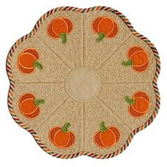 an orange placemat on top of a white surface with red and green trimmings