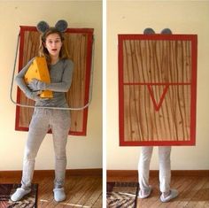 a woman standing in front of a cardboard box with mouse ears on her head and holding a piece of cheese