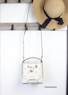 Style: Michael Kors Mercer Small Bucket Drawstring Handbag (Light Cream) Material: Embossed Pebbled Leather Features: Front MK Logo Plate Accent, Drawstring Closure, Adjustable/Detachable Crossbody Strap Measures: 7" H x 7.5" W x 4" D Michael Kors Spring Bags With Detachable Strap, Michael Kors Bucket Shoulder Bag With Detachable Strap, Michael Kors Pouch Shoulder Bag With Adjustable Strap, Michael Kors Bucket Shoulder Bag With Adjustable Strap, Michael Kors Bucket Bag With Gold-tone Hardware, Michael Kors Bucket Bag With Detachable Strap For Shopping, Michael Kors Bucket Bag For Shopping, Michael Kors Bucket Bag With Adjustable Strap, Michael Kors Crossbody Bucket Bag