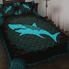 a bed with a shark quilt on it