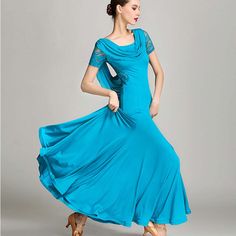 a woman in a blue dress is dancing