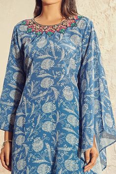 Blue kaftan-style kurta with all-over print, embroidered neckline, draped sleeve and asymmetric hem. Comes with sea green palazzo.
Component: 2
Printed, Embroidered
Neckline: Round
Sleeve Length: Full
Fabric: Crepe, Cotton
Color: Blue, Green
Asymmetric hem - Aza Fashions Unstitched Blue Bohemian Sets, Unstitched Bohemian Sets In Blue, Blue Bohemian Unstitched Sets, Blue Bohemian Sets Unstitched, Blue Bohemian Unstitched Dress, Blue Bohemian Kurta With Dupatta, Blue Printed Straight Kurta, Blue Chikankari Embroidery Palazzo Set For Summer, Blue Chikankari Embroidered Palazzo Set For Summer