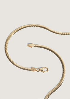 Elegant and sophisticated, herringbone chains date back to Ancient Egypt. They're often referred to as liquid gold, and will elevate any look. Looking for something slightly bolder? Shop our Kennedy Herringbone Chain II. Complete the look with the Carter Flat Herringbone Chain II. This is the thinner version of the Kennedy Herringbone Chain II.Features a lobster clasp for secure closure.Herringbone Care: Please note that herringbone chains require careful handling. We recommend storing them on a Gold Classic Herringbone Link Necklace, Classic Gold Herringbone Necklace With Snake Chain, Classic Gold Link Herringbone Necklace, Classic Herringbone Necklace With Box Chain For Formal Occasions, Classic 14k Gold Herringbone Chain Necklace, Classic Yellow Gold Snake Chain Necklace, Yellow Gold Herringbone Necklace For Formal Occasions, Classic 14k Gold Herringbone Necklace With Box Chain, Elegant Gold Herringbone Necklace With Curb Chain