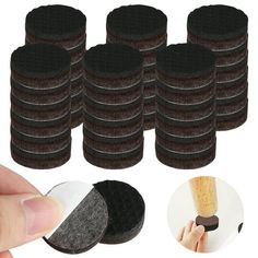 a hand holding a black sponge next to a pile of brown sponges on top of each other