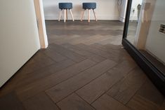 two stools sitting on top of a hard wood floor