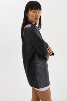 Indulge in the timeless elegance of the QUIRINA Leather Blazer, a quintessential addition to every discerning wardrobe. Crafted with a peaked lapel design and adorned with classic flap pockets, this blazer exudes sophistication and versatility. Its unlined construction ensures a feather-light feel, ideal for navigating transitional seasons with ease. Pair it effortlessly with jeans and a tee for an understated yet chic ensemble, or channel refined professionalism with the YAREN Leather Pants and Modern Notch Lapel Blazer Dress For Formal Occasions, Chic Formal Blazer Dress With Pressed Crease, Sleek Business Blazer Dress With Suit Collar, Modern Blazer Dress With Notch Lapel For Formal Occasions, Sleek Notch Lapel Blazer Dress For Business, Modern Formal Blazer Dress With Notch Lapel, Sleek Blazer Dress With Suit Collar For Business, Luxury Structured Blazer For Formal Occasions, Chic Formal Blazer Dress With Concealed Placket