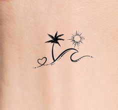 a small palm tree tattoo on the back of a woman's left side ribcage