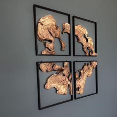 three pieces of wood are hanging on the wall next to each other in black frames