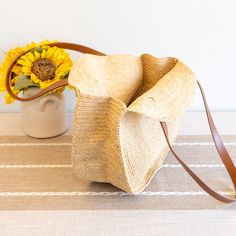 IN STOCK FAST SHIPPING FROM LOS ANGELES Step out in style with our versatile and spacious round tote bag! Made from durable raffia straw, this bag is perfect for both work and play. Featuring a genuine leather strap, it is designed to last and hold all your essentials. A must-have for your summer adventures, this popular shoulder tote is both functional and fashionable. Natural soft raffia straw Genuine leather straps Handmade Unlined Size: 14" Diameter x 5" Depth Strap drop length: 9" Designer Bucket Hobo Bag With Rolled Handles For Travel, Eco-friendly Straw Bag With Adjustable Strap For Everyday Use, Eco-friendly Jute Hobo Bag For Travel, Eco-friendly Jute Hobo Bag For Everyday, Eco-friendly Everyday Use Straw Bag With Adjustable Strap, Jute Shoulder Bag With Braided Round Handles, Jute Straw Bag With Round Handle For Travel, Natural Straw Hobo Bag With Adjustable Strap, Natural Bucket Bag With Rolled Handles For Travel