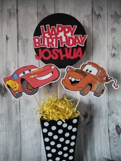 a birthday cake topper with cars on it