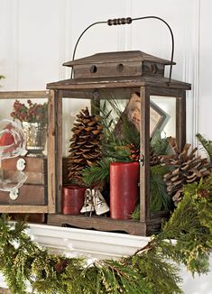 an old lantern with pine cones and candles