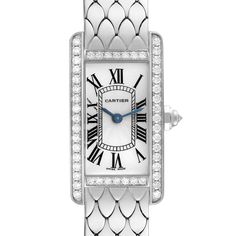 Cartier Tank Americaine White Gold Diamond Ladies Watch WB710009. Quartz movement. 18K white gold case 19.0 x 35.0 mm. Octagonal crown set with an original Cartier factory faceted diamond. 18k white gold original Cartier factory diamond bezel. Scratch resistant sapphire crystal. Silvered grained dial with black Roman numerals. Sword shaped blued steel hands. 18K white gold bracelet with hidden butterfly clasp. Fits 6.5" wrist. Cartier Tank Americaine, Cartier Calibre, Cartier Tank, White Gold Bracelet, Gold Case, Bezel Diamond, Ladies Watch, Roman Numerals, Sapphire Crystal