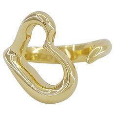 Tiffany & Co. 18K Yellow Gold Elsa Peretti Open Heart Ring is a charming and elegant piece of jewelry from the renowned luxury brand. Here's what you need to know about it: Material: Crafted from high-quality 18K yellow gold, this ring exudes warmth and richness, making it a timeless addition to any jewelry collection. Design: Designed by the legendary Elsa Peretti, this ring features an open heart motif, which is a signature design element of her collection with Tiffany & Co. The open heart sym Luxury Yellow Open Ring Jewelry, Tiffany Melody Ring, Luxury Gold Ring For Valentine's Day, Luxury Gold Rings For Valentine's Day, Luxury Heart Shaped Ring For Formal Occasions, Elegant Gold Double Heart Rings, Luxury Yellow Gold Open Heart Ring, Formal Yellow Gold Heart Ring For Valentine's Day, Elegant Gold Plated Heart Ring For Anniversary