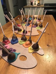 a wooden table topped with lots of cake pops