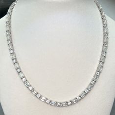 This is a DNS Jewelry exclusive in-house design with low profile open basket setting for enhanced sparkle, and our one of a kind spring loaded box clasp that does not fail over time like typical friction-style clasps. This dazzling tennis necklace looks beautiful and elegant, and will never go out of style. Perfect for a beautiful evening out.  Moissanite offers timeless beauty and exceptional value. The stones we use are GRA certified VVS1 clarity Moissanite. The details matter so we do not buy Elegant Moissanite Tennis Necklace With Brilliant Cut, Elegant Diamond Tennis Necklace With Baguette Cut, Elegant Moissanite Tennis Necklace For Anniversary, Elegant Baguette Cut Tennis Necklace For Anniversary, Diamond White Tennis Necklace With Baguette Diamonds, White Gold Diamond Tennis Necklace With Baguette Cut, Exquisite Brilliant Cut Tennis Necklace For Anniversary, Diamond White Cubic Zirconia Tennis Necklace With Baguette Diamonds, Luxury Baguette Cut Solitaire Necklace For Anniversary