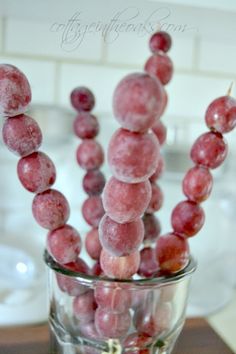 some grapes are in a glass on a table