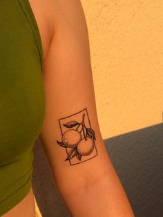 a woman's arm with a tattoo on it that has peaches and leaves