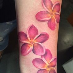 a woman's arm with pink flowers on it