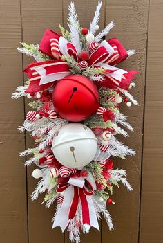 a christmas wreath hanging on the side of a wooden door with a football and candy canes