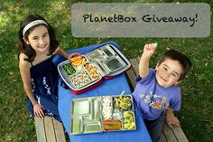 two young children sitting at a picnic table with lunches in front of them and the words planetbox giveaway