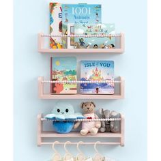 three shelves with books and stuffed animals on them