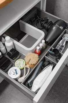 an open drawer with various items in it