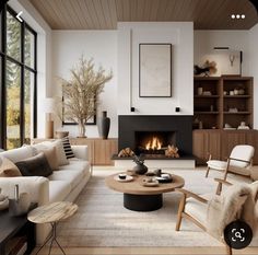 a living room filled with furniture and a fire place in the middle of the room