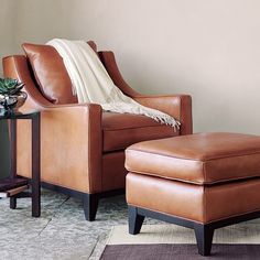 a chair and ottoman in a living room