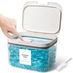 a person reaching into a container filled with blue beads