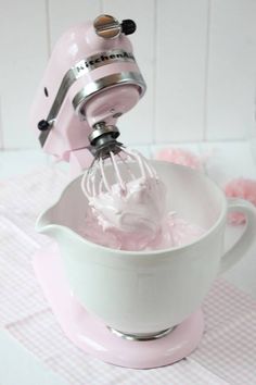 a pink mixer is being used to make ice cream