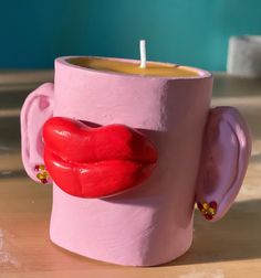 a candle holder made to look like a cup with lipstick on it