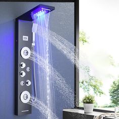 a shower head with water running from it's sides and blue lights on the side