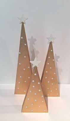 two paper christmas trees with white stars on them