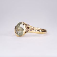 a close up of a ring with a stone in the middle on a white background