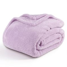 a purple blanket is folded on top of each other and it's very soft