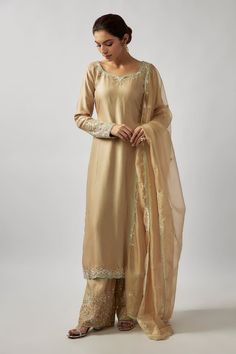 Champagne gold straight kurta with placement embellishments using glass beads, sequins work. Paired with a pant with floral embellishments and scallop trimmed dupatta. - Aza Fashions Golden Kurta Women, Traditional Gold Palazzo Set With Zari Work, Gold Palazzo Set For Eid With Traditional Drape, Gold Palazzo Set With Traditional Drape For Eid, Gold Semi-stitched Palazzo Set For Festive Occasions, Bollywood Style Gold Palazzo Set For Eid, Unstitched Gold Sharara With Resham Embroidery, Bollywood Gold Palazzo Set For Eid, Eid Gold Bollywood Palazzo Set