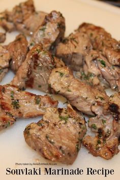 grilled meat with herbs on it sitting on a plate