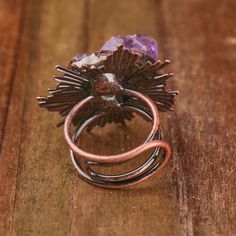 Immerse yourself in the allure of our Vintage Look Bronze Plated Adjustable Ring adorned with Natural Amethyst Crystals. Each ring is a unique masterpiece, with crystal sizes ranging from 21-25x14-16mm, creating a captivating vintage look. With a length of 32x39mm and a weight of 20g, this ring is a perfect blend of sophistication and style. Key Features: Vintage Look Design: The bronze-plated ring exudes a timeless aesthetic, reminiscent of vintage elegance. Natural Amethyst Crystals: Adorn you Adjustable Mystical Crystal Ring, Purple Mystical Jewelry Ring, Vintage Amethyst Jewelry For Healing, Mystical Amethyst Gemstone Rings, Mystical Amethyst Purple Ring, Mystical Purple Amethyst Rings, Unique Adjustable Crystal Ring With Stones, Vintage Amethyst Crystal Ring With Gemstone Detail, Adjustable Open Crystal Ring With Spiritual Style