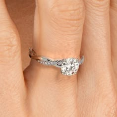 a woman's hand with a yellow gold ring and diamond set in the middle