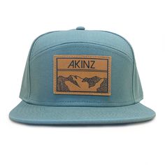 Our classic tradesman hat with a sustainable twist, made of alpine blue organic cotton with a full fabric back. Leather patch features the classic Akinz Elevation geometric mountains design. Hybrid 5 panel / flat bill fit. One size fits most. Adjustable back. LIMITED RUN. ONLY 12 AVAILABLE. Blue Curved Brim Hat For Hiking, Blue Snapback Hat With Curved Brim For Outdoor Activities, Blue Snapback Hat For Outdoor Activities, Blue Flat Brim Baseball Cap For Outdoor Activities, Blue 5-panel Hat For Outdoor Activities, Blue 5-panel Snapback Hat For Outdoor, Adjustable Snapback Hat With Flat Bill For Hiking, Adjustable Flat Bill Snapback Hat For Hiking, Blue 5-panel Snapback Hat With Logo Patch