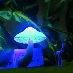 a mushroom lamp sitting on top of a green field