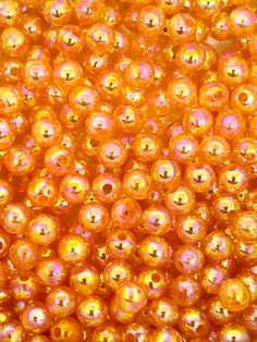 many orange beads are shown in this close up photo