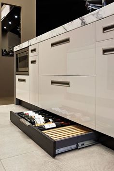 an open drawer in the middle of a kitchen