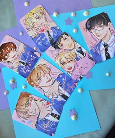 four anime character coasters on top of a blue and purple background with confetti sprinkles around them